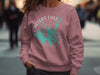 Pink crewneck sweatshirt with teal Carters Lake Georgia graphic and compass design.