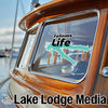 Teal map sticker with "Fellows Life" and "Lake Lodge Media LLC" text on a boat window.