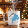 White mug with Lake Simcoe map and compass design, steaming coffee splash.