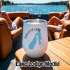 A white insulated travel tumbler with a blue Payette Lake graphic sits on a wooden boat table.