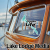 Turquoise Havasu Life logo on boat window, with Lake Lodge Media text below.