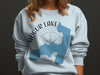Light blue crewneck sweatshirt with Augur Lake map, compass, and "New York" text.