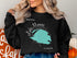 Black sweatshirt with a teal map of Lake Monroe, Florida.