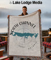 Man holding a North Channel Ontario map throw blanket with compass design.