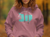 Manasquan Reservoir map in turquoise outline on a pink hooded sweatshirt.