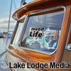 A teal lake graphic with "mead Life" text is on a boat window.