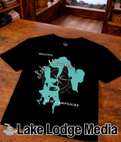 Black t-shirt with a turquoise outline of Lake Massabesic and compass.