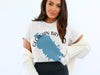 White t-shirt with blue Georgian Bay map graphic and compass design.
