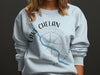 Light blue sweatshirt with "Lake Chelan Washington" text and a compass graphic.