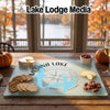 Glass cutting board featuring a Medina Lake map and compass rose design, surrounded by snacks.