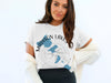 White t-shirt with blue Madison Lakes map graphic and compass design.