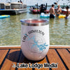 White insulated tumbler with Lake Hamilton compass graphic sitting on a wooden boat deck at the lake.