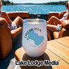 A white stemless wine tumbler with a Lake Calhoun Georgia map graphic sits on a wooden boat table.