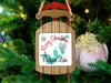 Sled ornament with "Merry Christmas From Reelfoot Lake" text hangs on a Christmas tree.