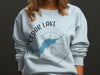 Light blue sweatshirt with Cedar Lake Ontario map and compass graphic.