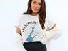 White t-shirt with "Folsom Lake California" text and lake map graphic.