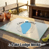 A glass cutting board featuring a blue map of Lake Mohave Arizona rests on a wooden dock.