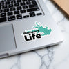 Rampart Life sticker with teal body of water silhouette on a laptop.