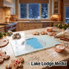 Textured glass cutting board featuring a blue Lake Tahoe map graphic, surrounded by baking items on a kitchen counter.