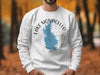 White sweatshirt with a blue Lake Monticello outline and compass graphic.