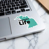 Lawtonka Life sticker on a laptop keyboard with a marble background.