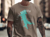 Taupe t-shirt with turquoise Lake Quivira outline and compass graphic.