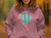 Rose pink hoodie with white text and teal Minnesota outline graphic.