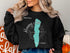 Black sweatshirt with teal "Honeoye Lake" map graphic and compass rose.