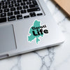 Turquoise outline sticker on laptop with "Tiorati Life" text.