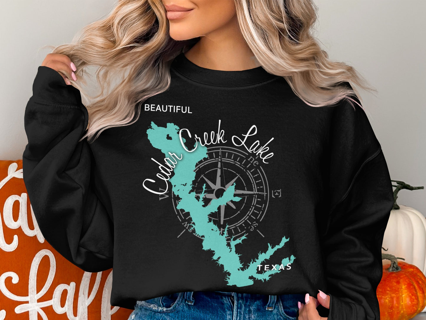 Black sweatshirt featuring a teal Cedar Creek Lake map and compass design.