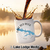 White mug with Lake Red Rock Iowa design, coffee pouring into it.