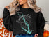 Black sweatshirt with Randleman Lake map and compass design.