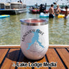 A white insulated wine tumbler with Longview Lake Missouri graphic resting on a wooden dock with people and boats in the background.