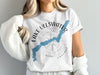 White t-shirt with a blue outline of Lake Ullswater and a compass rose design.