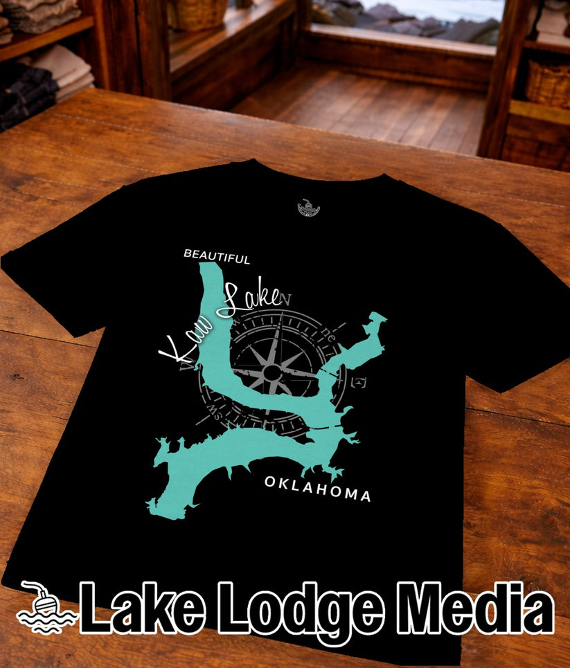 Black t-shirt with teal map outline of Kaw Lake, Oklahoma and compass rose.