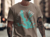Taupe t-shirt with a graphic of Lewisville Lake, Texas with compass design.