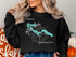 Black sweatshirt with Lake Wenatchee, Washington map and compass design.