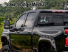 Black pickup truck with "Lake Lodge Media" and "mead LIFE" stickers on rear window.