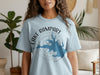 Light blue t-shirt with "Lake Rampart Colorado" text and lake outline compass design.