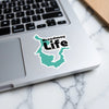 Sticker with teal map outline and text "Broadway Life" on a laptop.