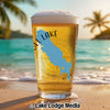 Glass of beer with a blue map of Michigan and "SLL LAKE" text on a beach.