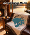 Woven blanket with Indian Lake map and "Ohio" text on a leather couch.