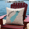 Cream pillow with Moraine Lake map and compass on Adirondack chair.