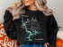Black sweatshirt with "Beautiful Mitchell Lake ALABAMA" map design and compass.