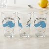 Three clear glasses with blue Lake Superior maps and compass designs.