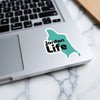 Turquoise Jordan Life sticker on a laptop keyboard.