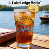 Glass of iced tea with "Noble Rock Lake" and map graphic, by a lake.