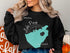 Black crewneck sweatshirt with "Lake Perris CALIFORNIA" map and compass design.