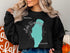 Black sweatshirt with turquoise Lake Winnebago Missouri map and compass graphic.