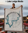 Tapestry featuring Summersville Lake map and compass, held by a smiling man.